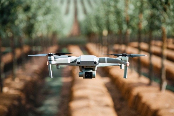 Compact drone flying over orchard rows (ID#2)