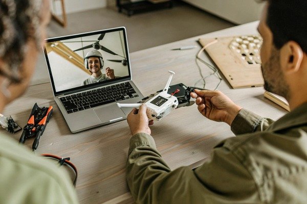 Man holding drone controller during video call (ID#2)