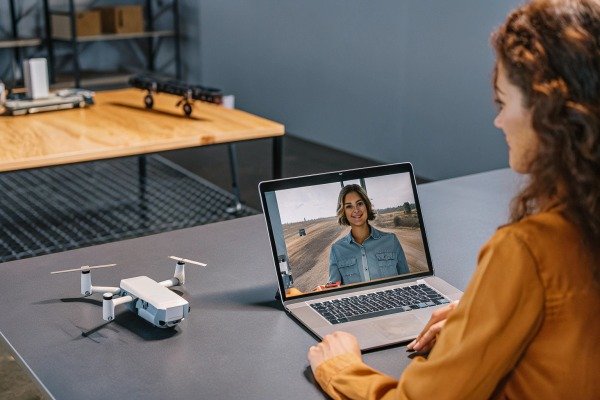 Woman video calling with drone on table (ID#4)