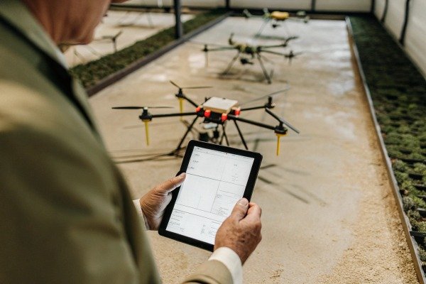 Person using tablet to control drone indoors (ID#2)