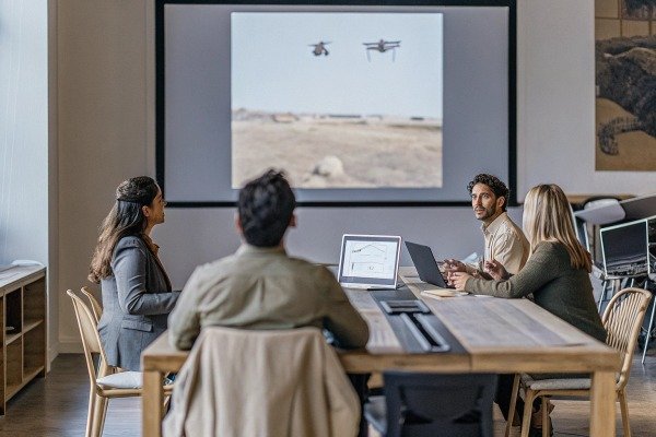 Team watching drone footage in meeting room (ID#4)