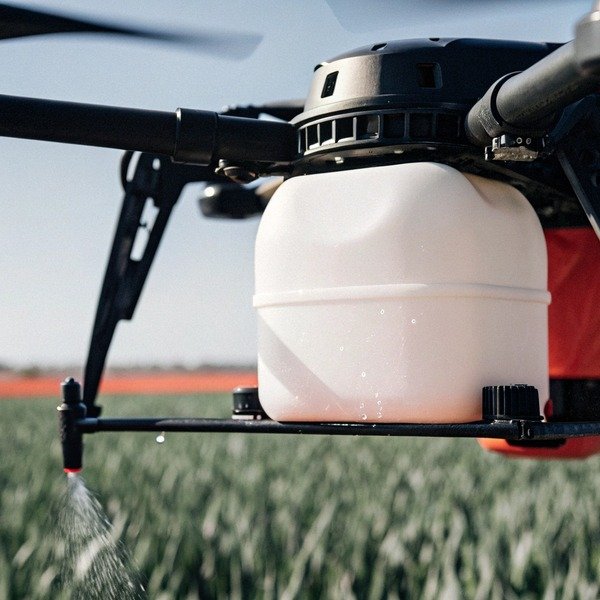 Drone spraying crops in field close-up (ID#1)
