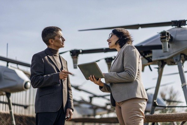 Two professionals discussing near drones (ID#3)