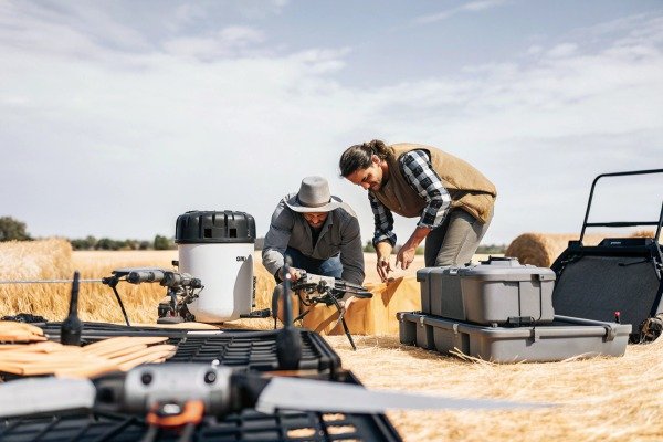 Technicians preparing drones in field (ID#5)