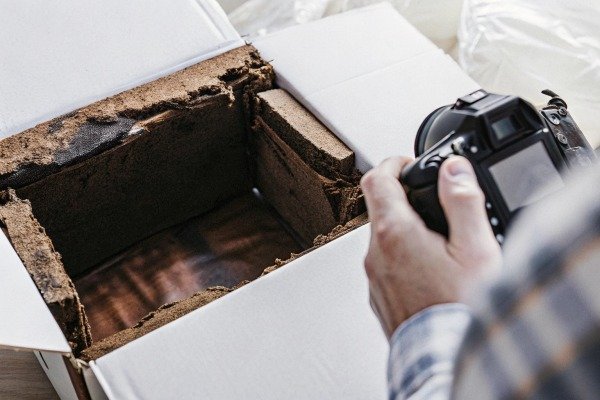 Man photographing damaged box close-up (ID#2)