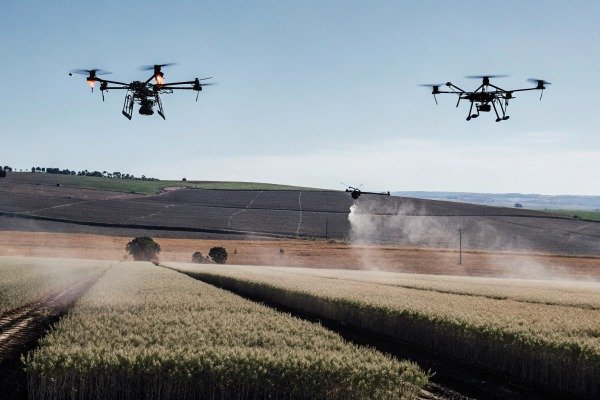 Two drones spraying crops over farmland (ID#5)
