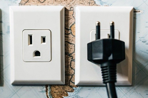 Electrical outlets on map background with plug inserted (ID#4)