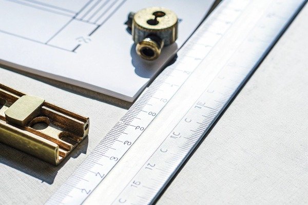 Measuring tools and blueprint on white surface (ID#4)