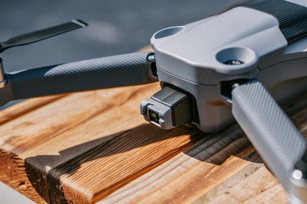 Close-up of drone camera and propellers on wood (ID#3)