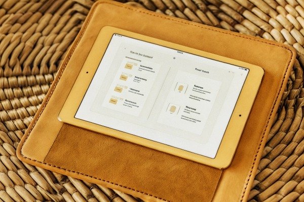 Tablet showing farm management app on leather case (ID#2)