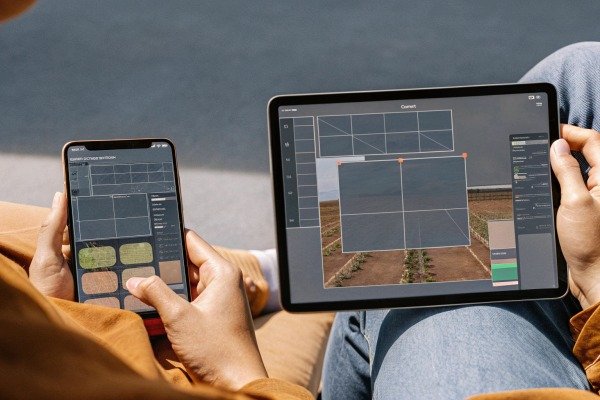 Hands using drone mapping software on devices (ID#3)