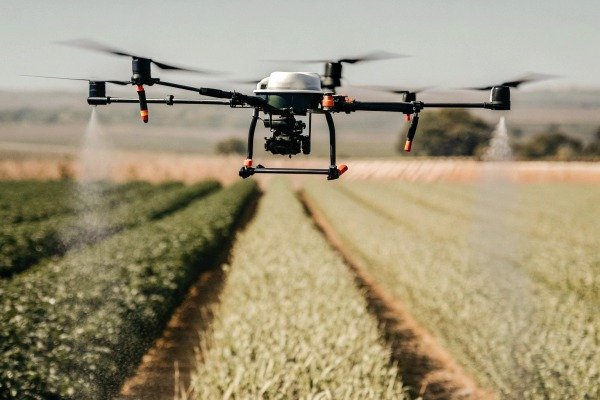 Drone spraying crops over farmland (ID#3)