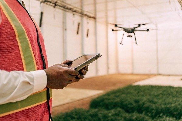 Person controlling drone inside greenhouse (ID#4)