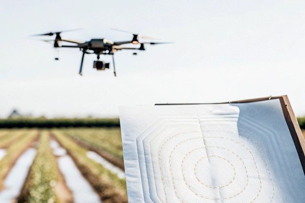 Drone flying over farmland with target board (ID#3)