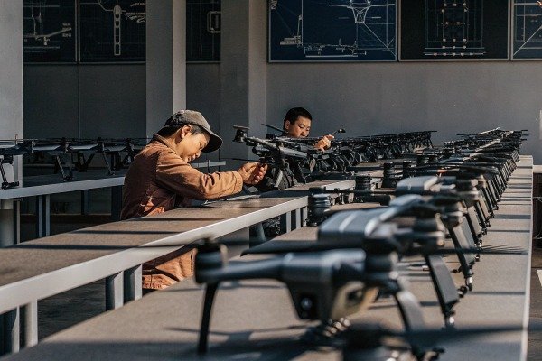 Drone assembly line Workers assembling drones in factory (ID#4)