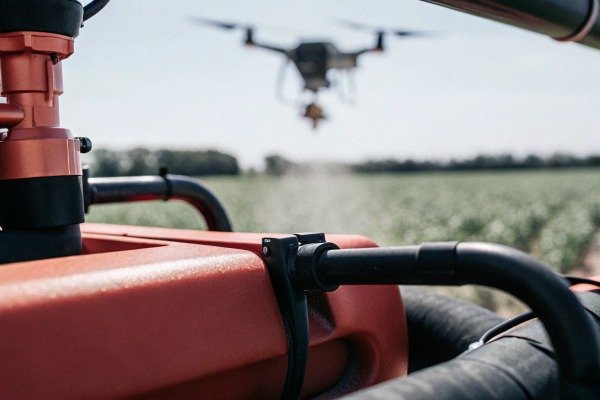 Drone spraying crops from vehicle (ID#3)