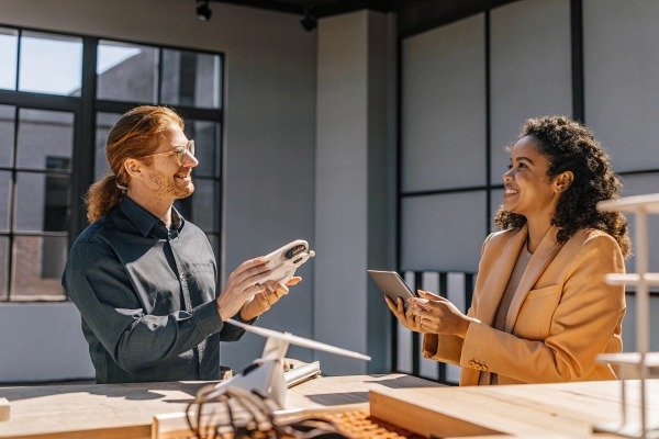 Two people discussing drone model in modern office (ID#5)