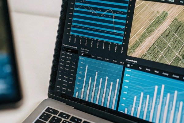 Laptop screen showing agricultural data graphs (ID#3)