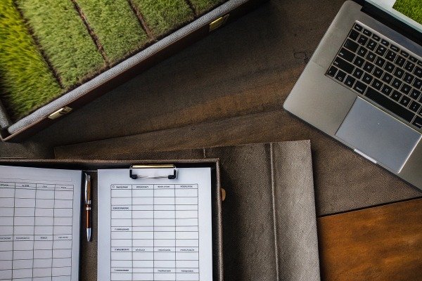 Agricultural documents and laptop on desk (ID#2)