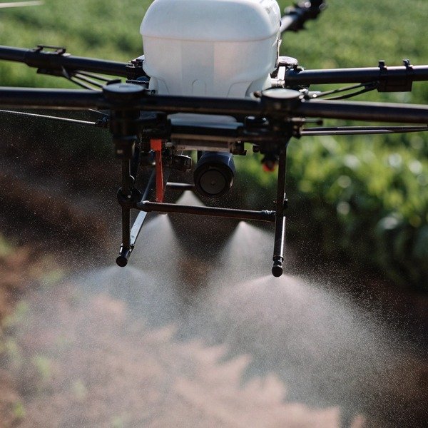 Drone spraying crops in field (ID#1)