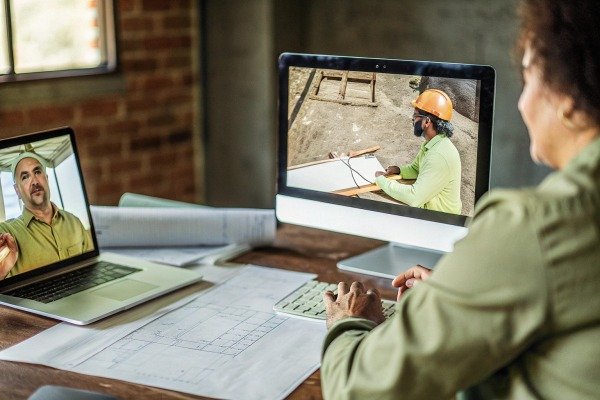 Woman video conferencing with engineers (ID#5)