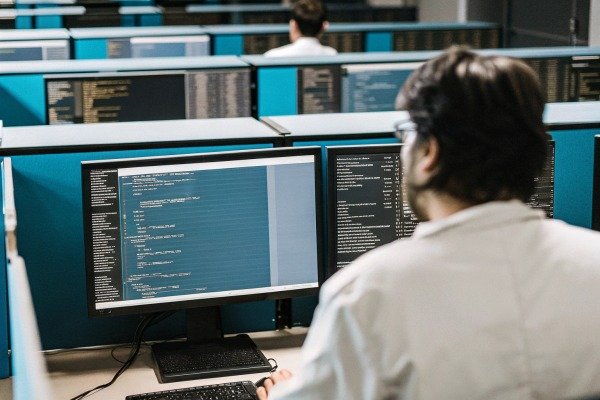 Man coding on computer in office (ID#2)