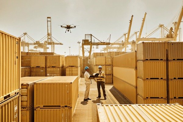 Drone flying over workers in shipping yard (ID#5)