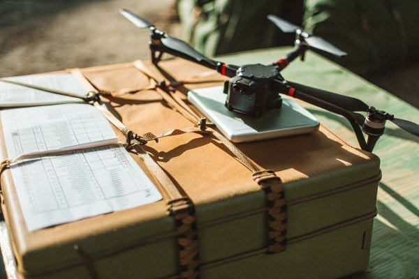 Drone Transport Case Setup Professional drone resting on top of a secured transport case with flight logs (ID#3)