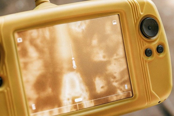 Handheld drone controller displaying a thermal heat map of a fire zone (ID#2)