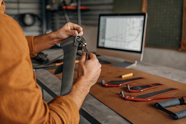 Technician assembling a carbon fiber drone propeller at a professional workshop desk (ID#3)