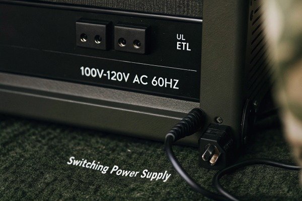 Close-up of a switching power supply label showing voltage and frequency specifications (ID#2)