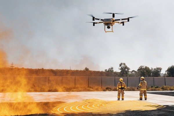 Modern quadcopter drone landing on a specialized landing pad outdoors (ID#4)