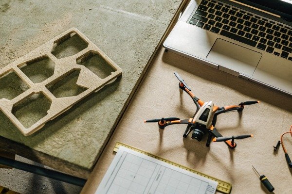 Modern quadcopter drone landing on a dedicated landing pad outdoors (ID#4)