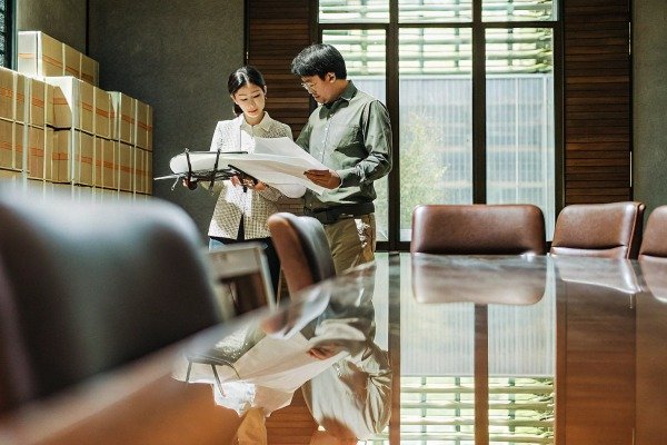 Modern drone landing on a portable landing pad in a grassy area (ID#5)