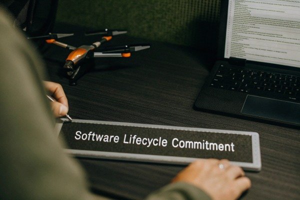 Modern quadcopter drone hovering in a clear blue sky (ID#4)