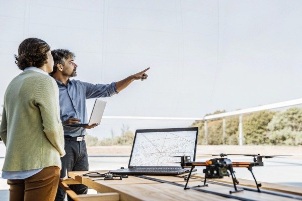 Drone pilot using a remote controller with a smartphone screen attached (ID#3)